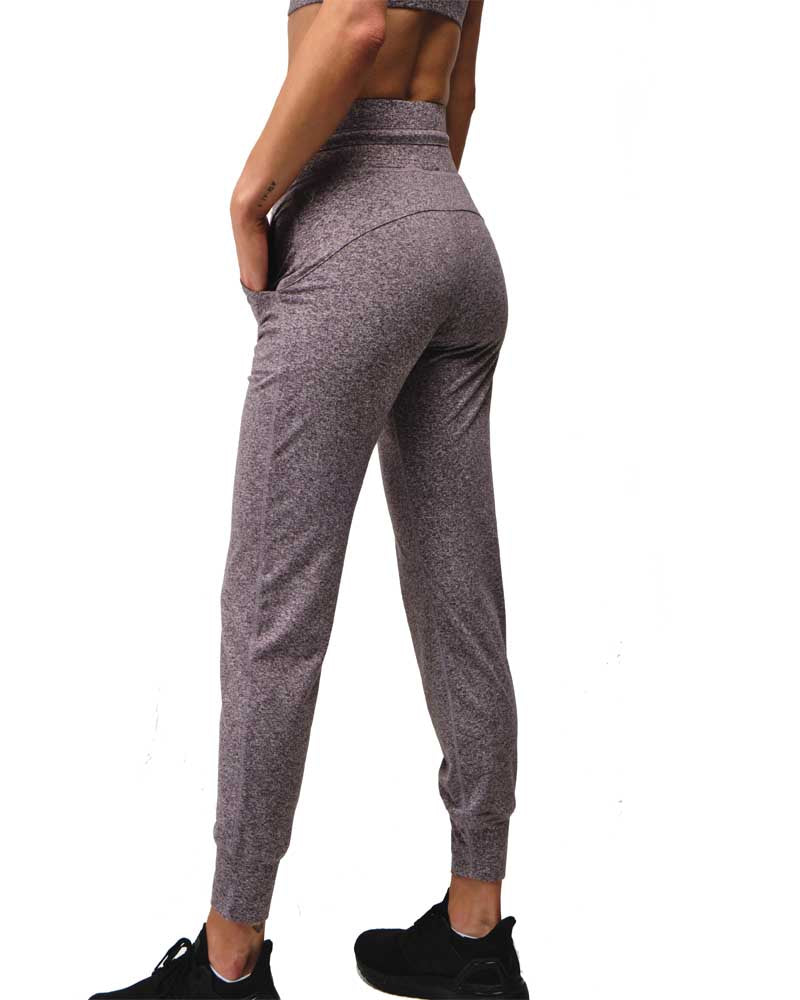 Gray jogger pants worn by a person on a white background
