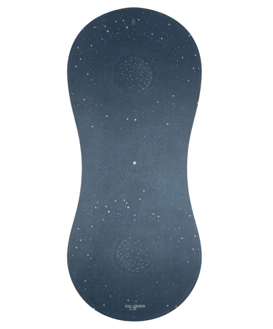 A dark blue-gray contoured yoga mat with a white starry galaxy pattern and subtle mandala designs, shown on a plain white background.
